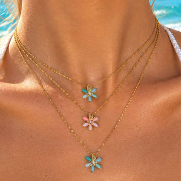 Gold-tone necklace with turquoise flower charms and small pink and blue accents