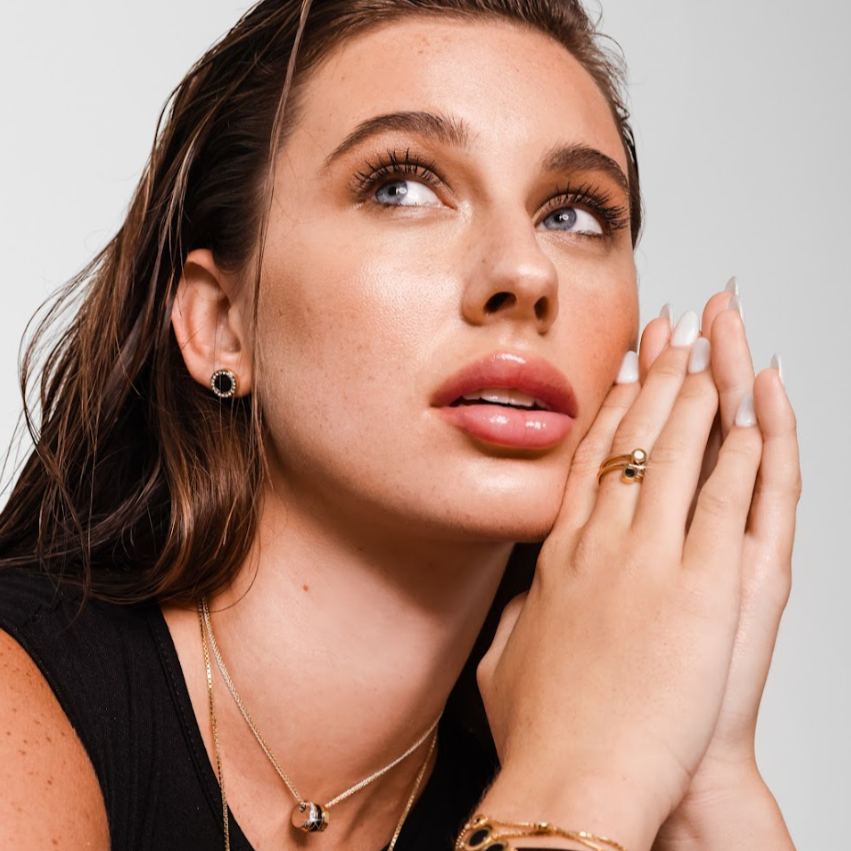 Woman modeling Jason Hyde ring, earring, and necklace