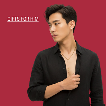 Man modeling a gold cross necklace and black shirt on a red background