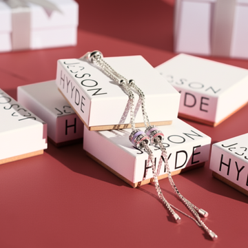 Many Jason Hyde gift boxes with two necklaces on top of one box