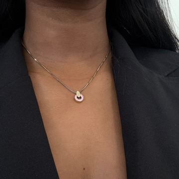 Delicate Nereida gold chain necklace and fondant pink chip on a woman's neck