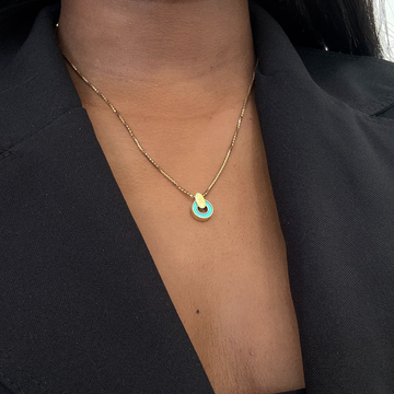 Nereida gold chain necklace  with turquoise chip on a woman's neck