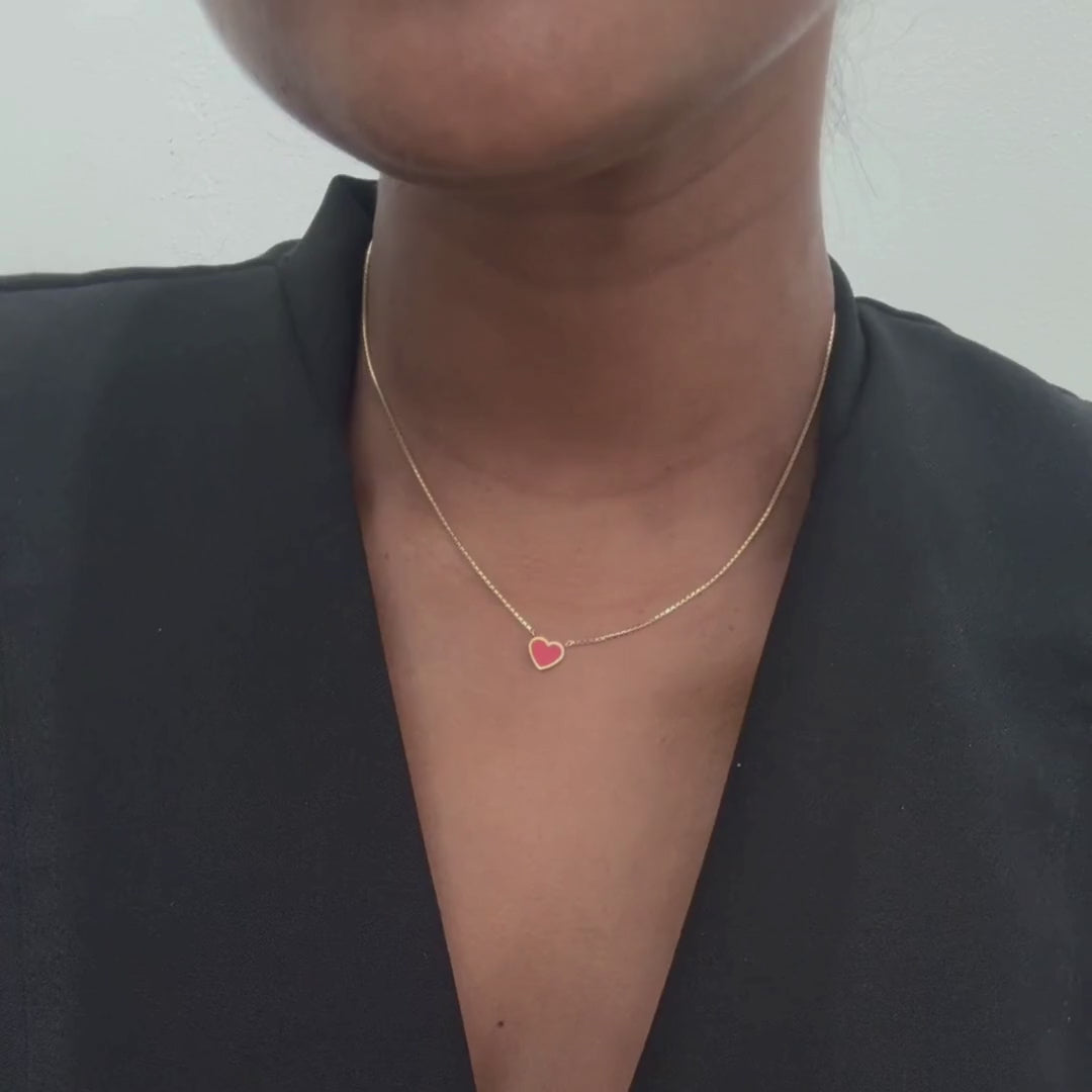 Silent video of a woman wearing a Jason Hyde Amare red chip necklace